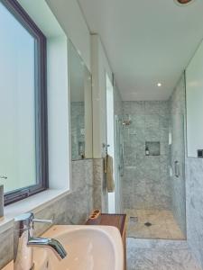 a bathroom with a sink and a shower at Parua Bay home with everything you'll need in Parua Bay