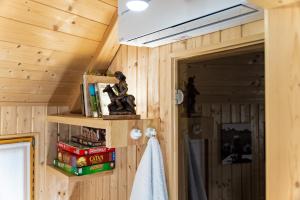 a room with wooden walls and a ceiling with a shelf at Alpine Chalet Velika Planina - Irenca - I Feel Alps in Stahovica +14 photos
