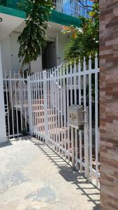a white picket fence in front of a house at Casita Natural Village #6 y #8 in San Juan