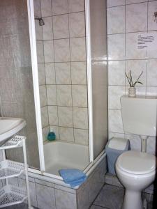 ein Badezimmer mit einer Badewanne, einem WC und einem Waschbecken in der Unterkunft Haus Stuttgart in Obernberg am Inn