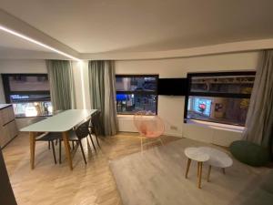 a living room with a table and chairs and windows at Sunset83700 in Saint-Raphaël
