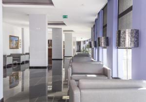 a row of couches in a waiting room at Praia da Rocha Apartments in Portimão