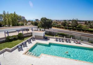 a swimming pool on top of a building at Praia da Rocha Apartments in Portimão