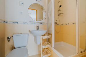 a bathroom with a toilet and a sink and a shower at Willa Karol in Karwia +39 photos