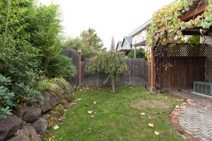 a backyard with a fence and a tree in the yard at Columbia West condo in Hood River