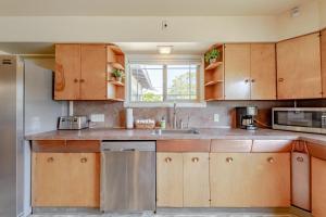 a kitchen with wooden cabinets and a sink and a window at Classy Craftsman in Arcata