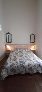 Un dormitorio con una cama con una manta. en Tradicional Algarvian House, en Albufeira