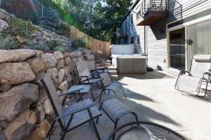 a patio with chairs and a stone wall at Downwider at The Columbia River Gorge in Hood River