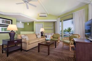 a living room with a couch and a tv at Wyndham Mauna Loa Village in Kailua-Kona
