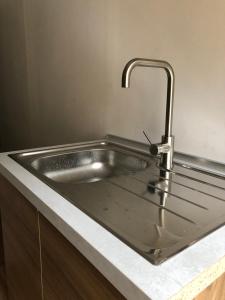 a stainless steel sink with a faucet in a kitchen at B&B Degli Artisti Suite in Lecce +39 photos