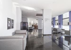 a lobby with couches and chairs in a building at Praia da Rocha Apartments in Portimão