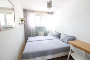 a small bedroom with a bed and a desk at Mon Appart A GERLAND IV in Lyon