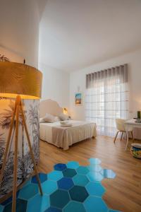 a bedroom with a bed and a blue hexagonal floor at La Serenata Luxury in Maiori