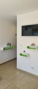 a room with two green and white shelves on a wall at alex appartement in Roquebrune-Cap-Martin