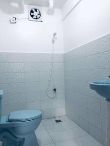a bathroom with a toilet and a sink at RB Baruiz "Hideaway" Inn - Cebu South in Cebu City
