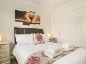 a bedroom with two beds with towels on them at Riverside Cottage in Cockermouth