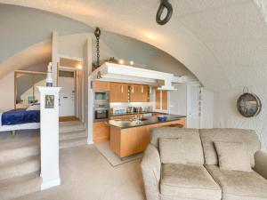a kitchen and a living room with a couch and a sink at Cannons Folly in Torpoint