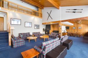 a waiting room with couches and chairs and a table at Valhalla Perisher in Perisher Valley