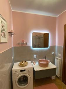 a bathroom with a washing machine and a mirror at CASA VACANZA FELICITA' in Porto Potenza Picena