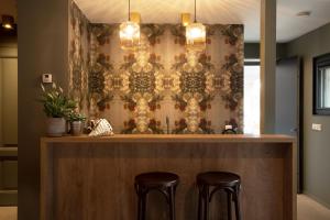 a bar with two stools in front of a wall at Adelaerthoeve Logies & Ontbijt in Arnhem