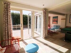 a living room with sliding glass doors and a pool table at Arlington House in Matlock