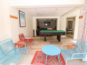 a living room with a pool table and chairs at Arlington House in Matlock