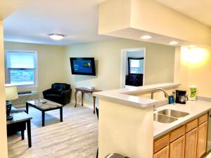 a kitchen with a sink and a living room at Bicentennial Inn in Buckhannon