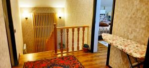 a hallway with a stairway leading to a room at Dom Semya Deluxe Gusar in Qusar