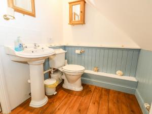 a bathroom with a sink and a toilet and a tub at The Coach House in Ryde +30 photos