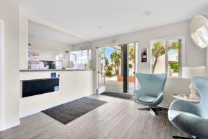 a living room with a couch and a chair and a table at Tradewinds Motel in Lakewood