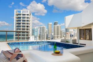 a pool on the roof of a building with a city at Ocean Royale in Gold Coast