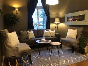 a living room with a couch and a table and chairs at Moss Hotel & Apartments in Moss