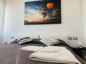 a bedroom with a bed with two hot air balloons at Napolidays Toledo Apartment By Dimorra in Naples