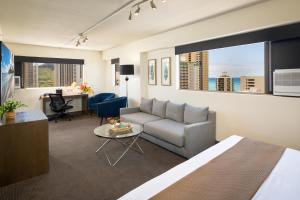 a living room with a couch and a table at VIVE Hotel Waikiki in Honolulu
