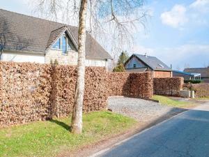 a stone fence in front of a house at Lush holiday home on the edge of the Hautes Fagnes in Waimes