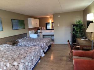 a hotel room with two beds and a kitchen at Fairview Inn in Fairview