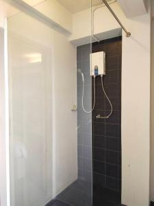 a shower with a glass door in a bathroom at Aileen Hotel in Khon Kaen