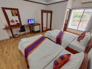 Postel nebo postele na pokoji v ubytování WeRest Hotel