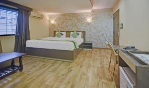 a hotel room with a bed and a kitchen at Treebo Savoury Sea Shell Residency in Bengaluru