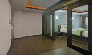 a bedroom with a bed and a sliding glass door at Treebo Savoury Sea Shell Residency in Bengaluru