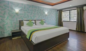 a bedroom with a large bed in a room at Treebo Savoury Sea Shell Residency in Bengaluru