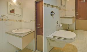 a bathroom with a toilet and a sink at Treebo Savoury Sea Shell Residency in Bengaluru