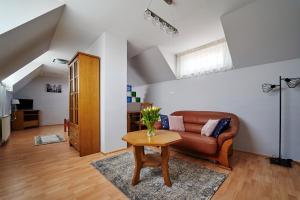a living room with a couch and a table at Hotelik Gołdap in Gołdap