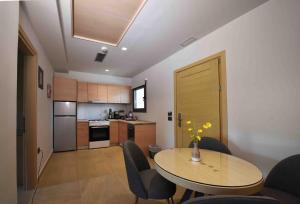 a kitchen with a table and chairs in a room at MIRAMARE LUXURY APARTMENTS in Eretria