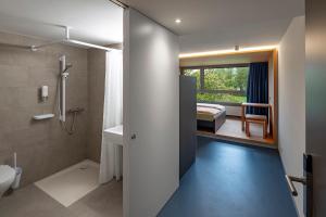un bagno con doccia e servizi igienici e una camera da letto di Rapperswil-Jona Youth Hostel a Rapperswil-Jona