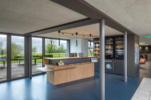 an office lobby with a reception desk and windows at Rapperswil-Jona Youth Hostel in Rapperswil-Jona