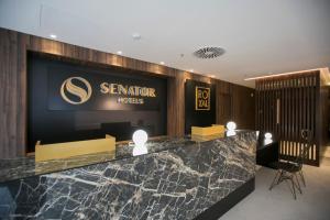a hotel lobby with a sign on the wall at Senator Gandia in Gandía