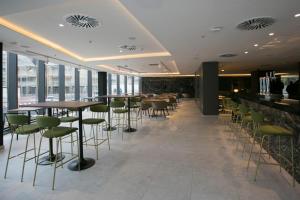 a restaurant with tables and chairs and windows at Senator Gandia in Gandía
