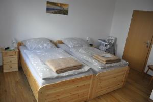 a bed in a room with two pillows on it at Ferienhaus Groß Moorburg in Südbrookmerland