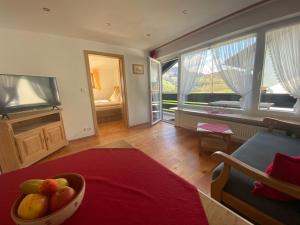 a living room with a bowl of fruit on a table at Ferienwohnungen Anger in Oberstdorf